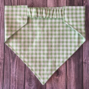 May include: A triangular pet bandana featuring a light green and white gingham check pattern. The fabric accessory includes a gathered elasticized neckband at the top edge, designed to slip over a collar for a secure and comfortable fit.