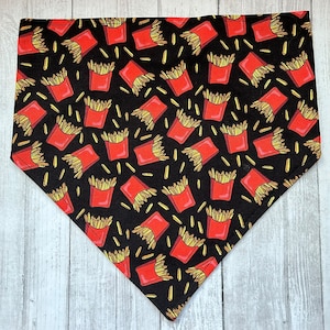 May include: Black bandana with a repeating pattern of red and yellow french fries. The fries are in a red box with a white outline.