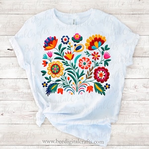 May include: White t-shirt featuring a vibrant floral design with colorful embroidered flowers in red, yellow, blue, and orange. The design includes the text "Bee Digital Crafts" at the bottom.