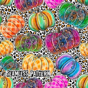 May include: A seamless pattern featuring colorful pumpkins in shades of orange, green, pink, and blue, set against a white background with black leopard print spots. The text "SEAMLESS PATTERN" is displayed at the bottom.