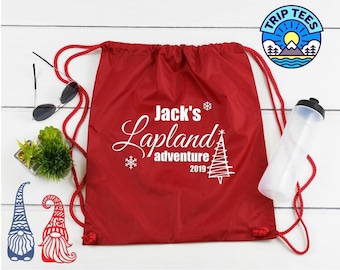 May include: Red drawstring bag with white text that says "Jack's Lapland Adventure 2019" with a snowflake and a stylized Christmas tree.