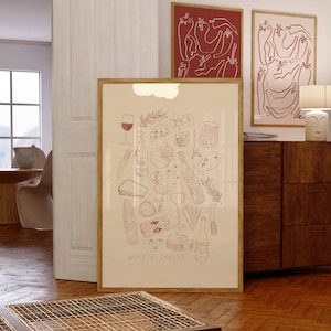 Puede incluir: Una ilustración enmarcada de un maridaje de vino y queso. La ilustración es de color rojo y presenta una variedad de quesos, botellas de vino, vasos, aceitunas y pan. El texto "WINE + CHEESE" está en la parte inferior de la ilustración.
