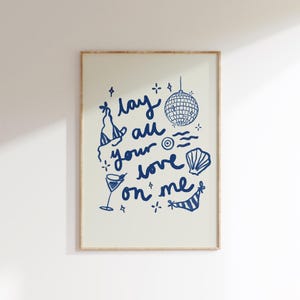May include: A blue and white illustration of a disco ball, a cocktail glass, a seashell, and a bikini top with the text "lay all your love on me".