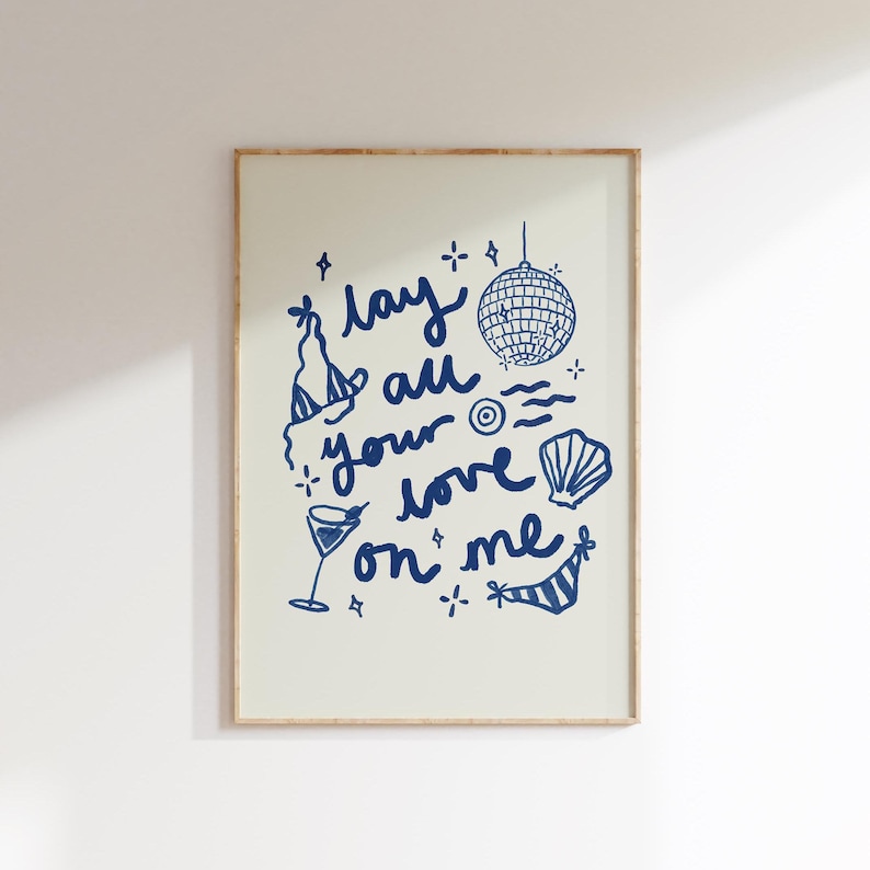 May include: A blue and white illustration of a disco ball, a cocktail glass, a seashell, and a bikini top with the text "lay all your love on me".