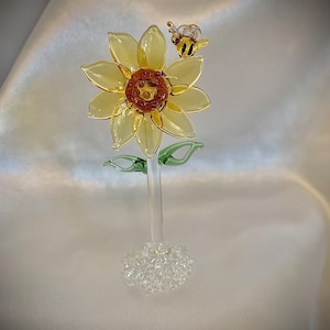 Tiny sunflower with bee