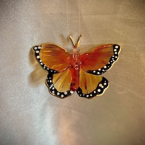 Tiny hanging monarch butterfly