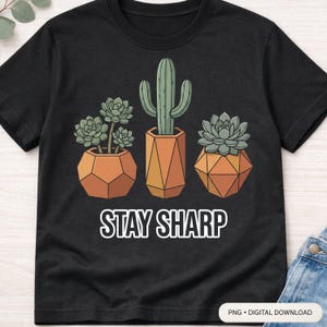 Puede incluir: Camiseta negra con un gráfico de tres suculentas en macetas y el texto "STAY SHARP" en blanco. Las suculentas son verdes y las macetas son naranjas con diseños geométricos. Descarga digital.