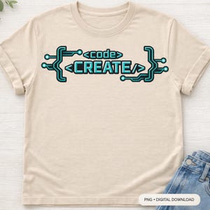 May include: A light beige t-shirt with the words "code CREATE" in a teal and black circuit board design. The shirt is made of a soft material and has rolled-up sleeves. The bottom right corner of the shirt is partially visible.