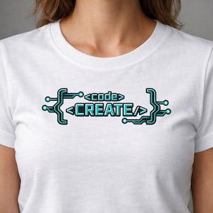 May include: White t-shirt with a teal and black graphic that reads "<code> CREATE". The design resembles a circuit board, with the words placed between stylized brackets and circuit elements. The shirt is made of a soft material.