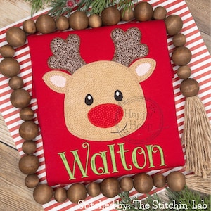 May include: Red Christmas shirt with an embroidered reindeer face and the name "Walton" in green embroidery.