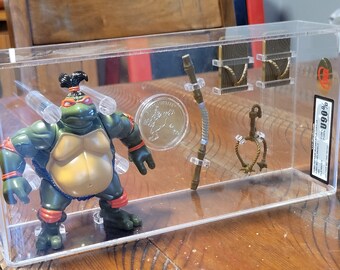 Holy Grail 1995 TMNT SUMO Michaelangelo Professionally Graded Perfect Uncirculated 90 by UKG Awesome Display with weapons and coin. Rare