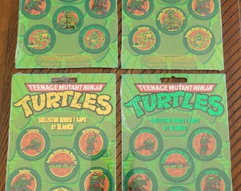 Lote de 4 Pogs TMNT SlamCo de 1993, lacrados na embalagem original.