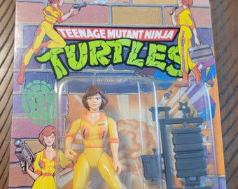 Crachá de imprensa da April O'Neil, figura de ação vintage das Tartarugas Ninja de 1990, intacto.