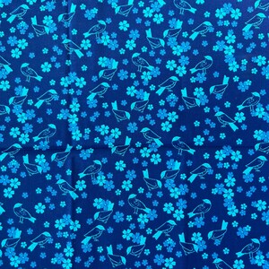 May include: A blue fabric with a repeating pattern of light blue birds and flowers. The birds are stylized and have a simple design. The flowers are small and have five petals.