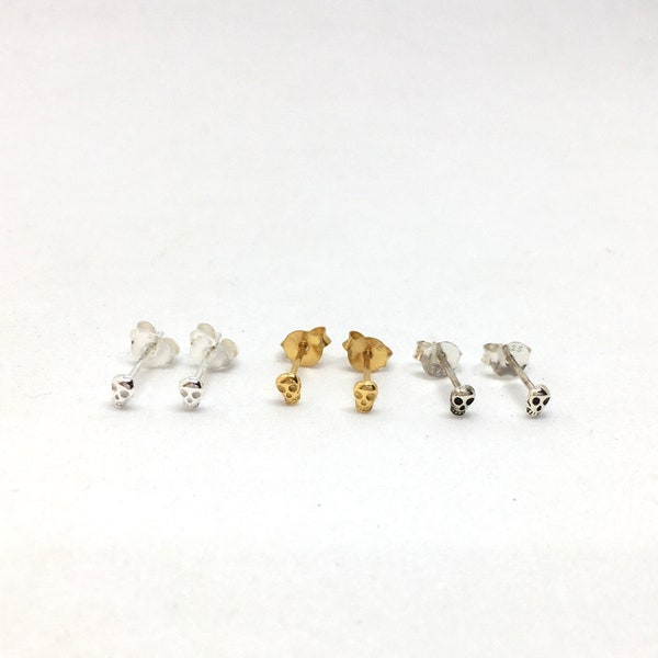 A pair of cute tiny SKULL gothic sterling silver or yellow gold plated silver stud earrings