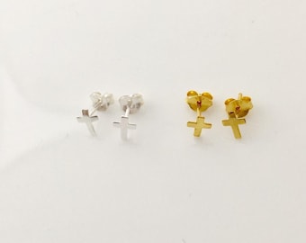 A pair of small sterling silver or yellow gold plated silver religious cross studs earrings