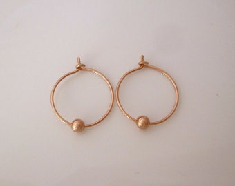 A pair of thin wire hoops with ball bead charms in solid sterling silver, 14K yellow or rose gold filled wire