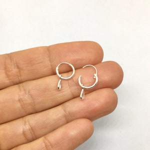 A pair of small cz teardrop charms sterling silver small hoops, charmed hoops