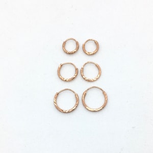 A pair of small laser cut 8mm, 10mm or 12mm rose gold plated sterling silver hoops