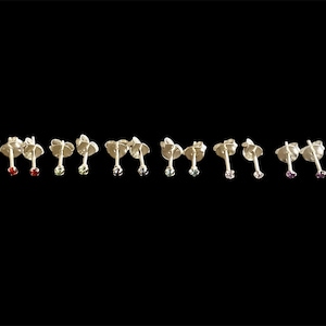 A pair of teeny tiny 1.5mm crystal sterling silver stud earrings, minimal studs