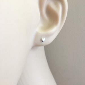 A pair of teeny tiny heart 925 sterling silver stud earrings