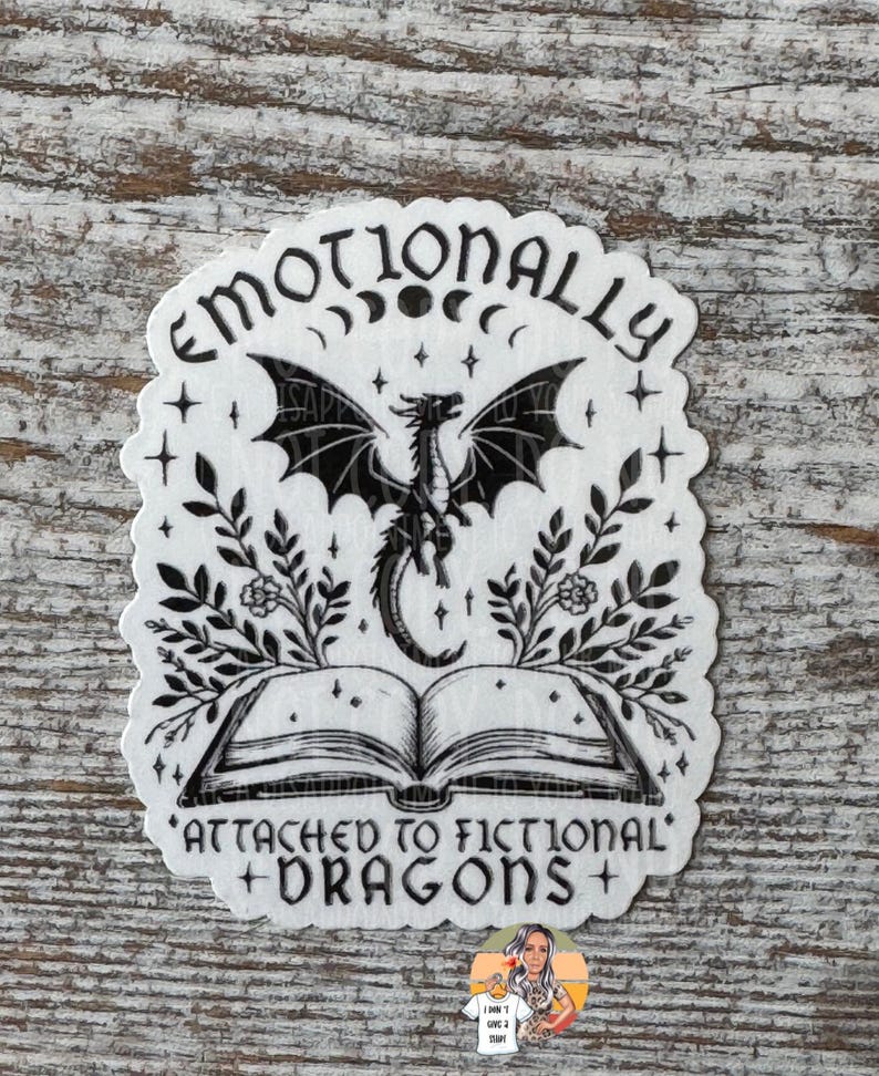 May include: Black and white sticker with a dragon, book, and the text "Emotionally Attached to Fictional Dragons".