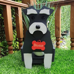 May include: Black wooden planter shaped like a miniature schnauzer dog with a red bone-shaped tag that says "Buster".