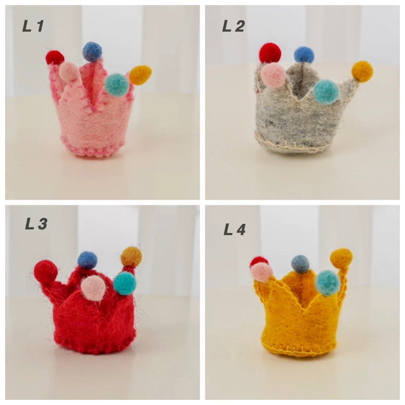 May include: Four small felt crowns labeled L1, L2, L3, and L4. L1 is pink, L2 is gray, L3 is red, and L4 is yellow. Each crown features five points topped with small, multicolored felt balls in red, blue, light blue, pink, and yellow.