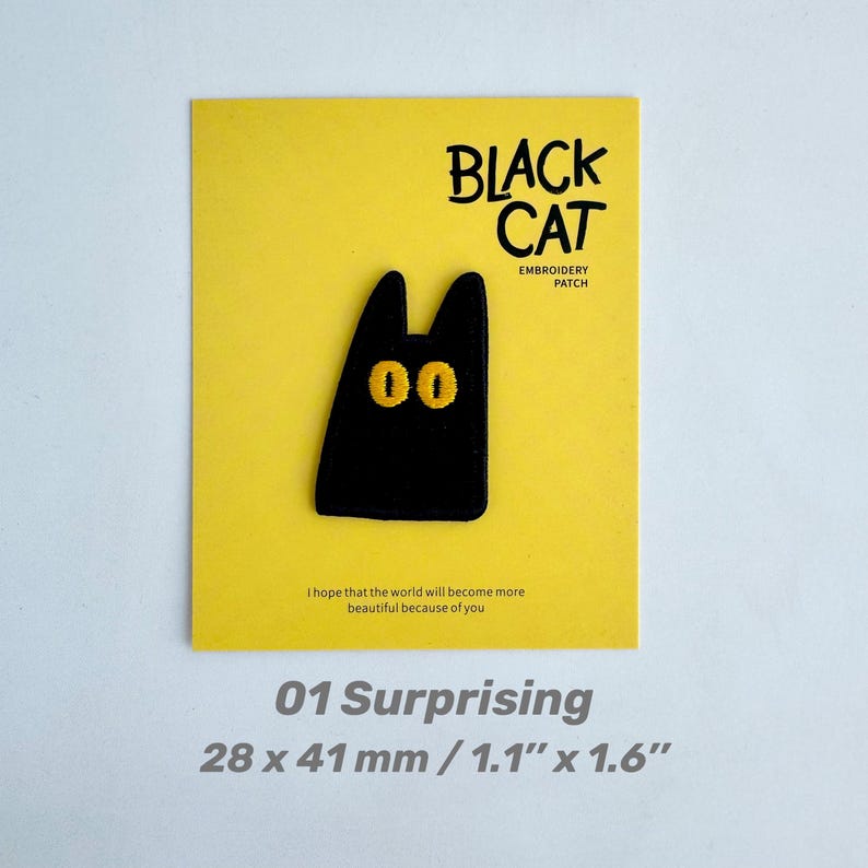 May include: A black cat embroidery patch with yellow eyes, displayed on a yellow card. The card reads "BLACK CAT EMBROIDERY PATCH" and "01 Surprising". The patch measures 1.1" x 1.6". The text "I hope that the world will become more beautiful because of you" is also present.