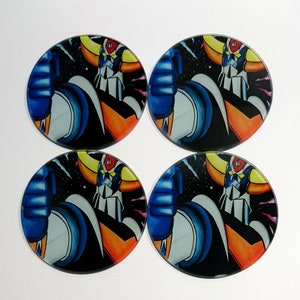 May include: Set of four round glass coasters featuring a colorful illustration of a robot in space. The robot is blue, orange, and yellow with a black background.