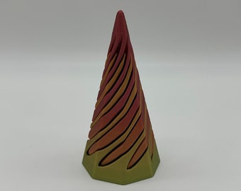 May include: A multi-colored, geometric cone-shaped object with a spiral pattern. The cone is made of a smooth, plastic-like material and has a red, orange, and yellow color gradient.