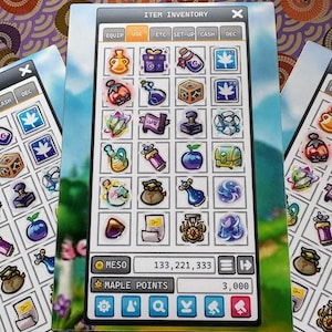 May include: A close-up of several game cards featuring an "Item Inventory" interface with various icons representing items. The cards display numbers for "Meso" and "Maple Points". The background has a purple and brown circular pattern.