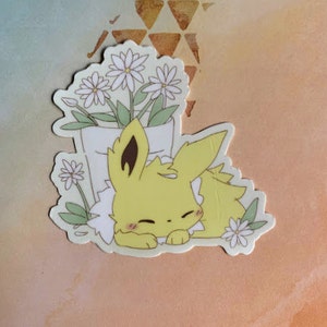 May include: A yellow cartoon character with a white flower pot on its head, surrounded by white flowers. The character is sleeping with its eyes closed.