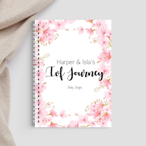 May include: A white journal with a pink floral design and the text "Harper & Isla's IVF Journey" and "Fertility Designs".