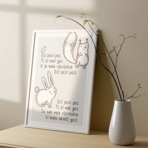May include: A framed print featuring a whimsical illustration of a squirrel and a rabbit. The artwork is in soft neutral tones and includes text in a playful font. A small bird is also depicted. The print is displayed on a wooden surface.