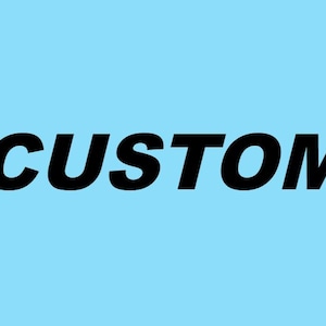 May include: The word CUSTOM is written in bold, black, sans-serif capital letters centered against a solid, light blue background. The text is oriented horizontally and features a clean, modern typeface that stands out clearly against the backdrop.