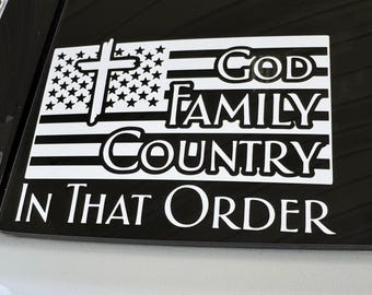 May include: A white decal featuring an American flag design with a cross, stars, and stripes. The words "GOD FAMILY COUNTRY IN THAT ORDER" are displayed in bold, white lettering, emphasizing the order of priorities.