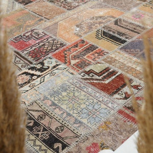 May include: A patchwork rug with a variety of colors and patterns, including red, blue, green, and brown. The rug is made of different pieces of fabric that have been sewn together.