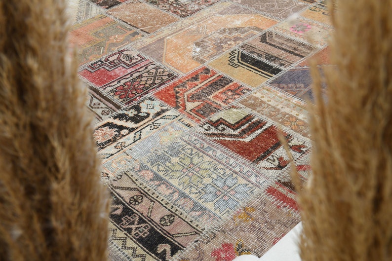 May include: A patchwork rug with a variety of colors and patterns, including red, blue, green, and brown. The rug is made of different pieces of fabric that have been sewn together.