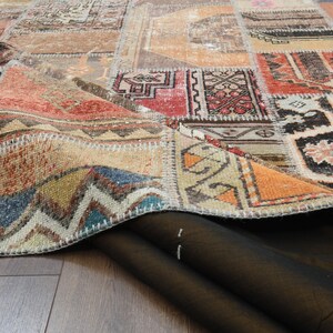 May include: A close-up of a colorful patchwork rug with a variety of patterns and colors, including red, blue, green, and yellow. The rug is folded in half, revealing the underside of the fabric.