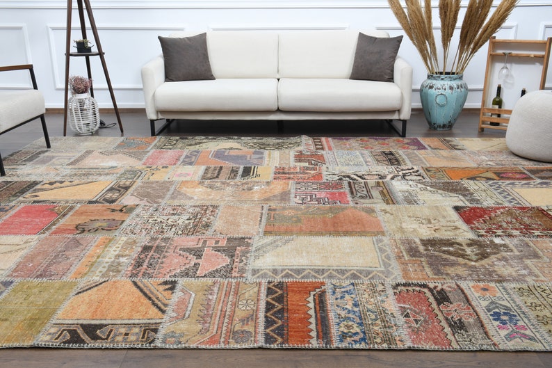 May include: A patchwork rug with a variety of colors and patterns, including red, orange, brown, and blue. The rug is made up of different pieces of fabric that have been sewn together.