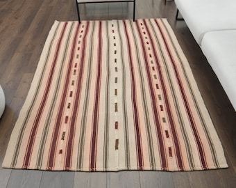 May include: A striped rug with a cream background and red, brown, and beige stripes. The rug has a woven texture and is made of natural fibers.