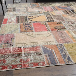 May include: A patchwork rug with a variety of colors and patterns, including red, orange, brown, and beige. The rug is made of different pieces of fabric that have been sewn together.
