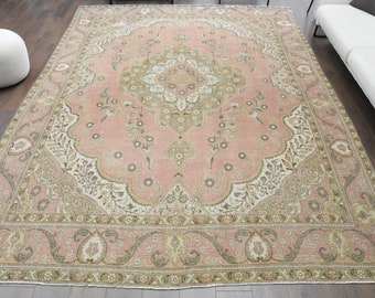 May include: A vintage pink and cream rug with a floral pattern and intricate details. The rug has a faded, distressed look, giving it a unique and antique feel.