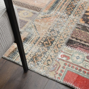 May include: A patchwork rug with different colored patterns and textures. The rug is made of various pieces of fabric sewn together. The rug is a mix of beige, brown, red, and orange colors.