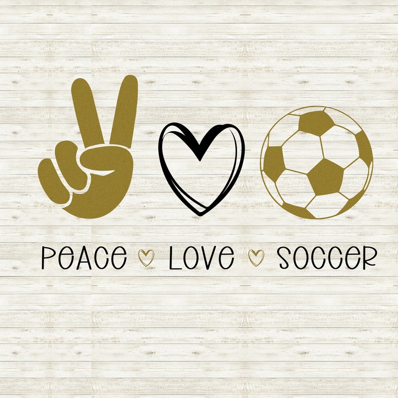May include: Peace, love, and soccer graphic with a peace sign, heart, and soccer ball in gold on a white wood background.