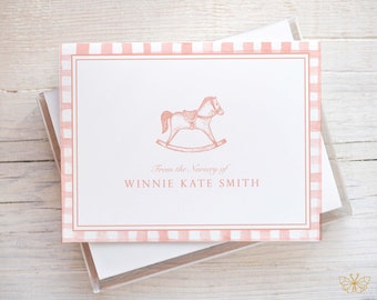 May include: Pink and white gingham stationery set with a rocking horse illustration and the text "From the Nursery of WINNIE KATE SMITH".