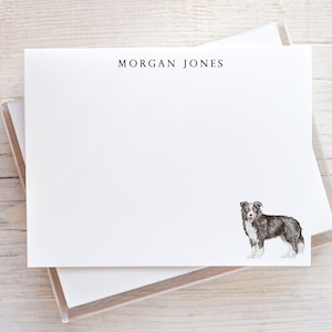May include: White stationery with the name "MORGAN JONES" printed at the top. A watercolor illustration of a black and white Border Collie dog is in the lower right corner. The stationery is in a clear plastic case.