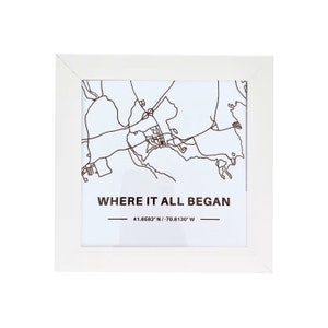 May include: White framed print with a black and white map of a city. The text "WHERE IT ALL BEGAN" is printed below the map, with the coordinates "41.6583&deg; N / 70.8130&deg; W" printed below the text.