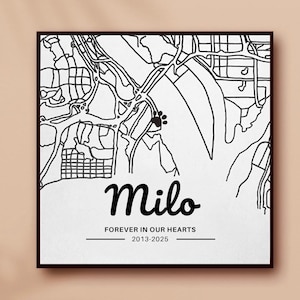 May include: Black and white framed print featuring a map design with a paw print. The name "Milo" is written in cursive, with the text "FOREVER IN OUR HEARTS 2013-2025" below. The print has a black border and is set against a beige background.